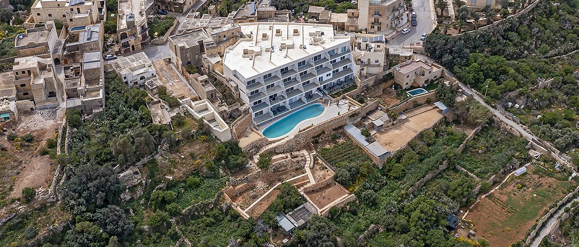 A valley’s ecology and ridge vistas damaged as imposing blocks of flats with pools rise on ridges