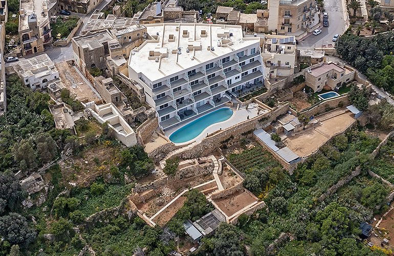 A valley’s ecology and ridge vistas damaged as imposing blocks of flats with pools rise on ridges